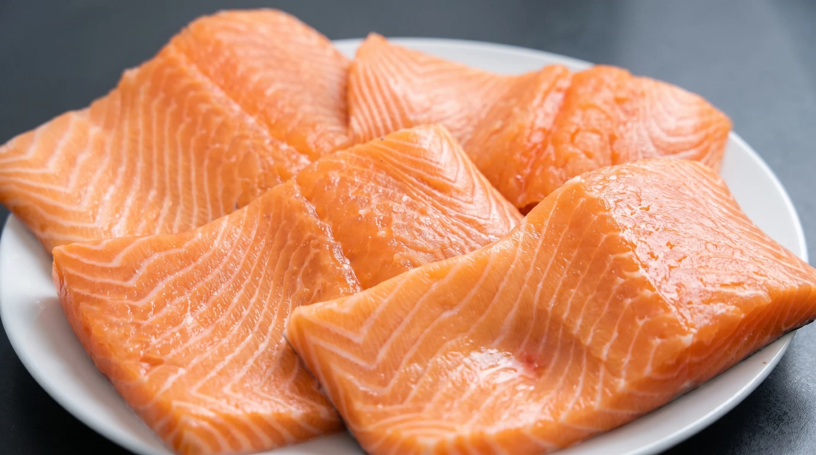 Fresh salmon fillets arranged on a plate