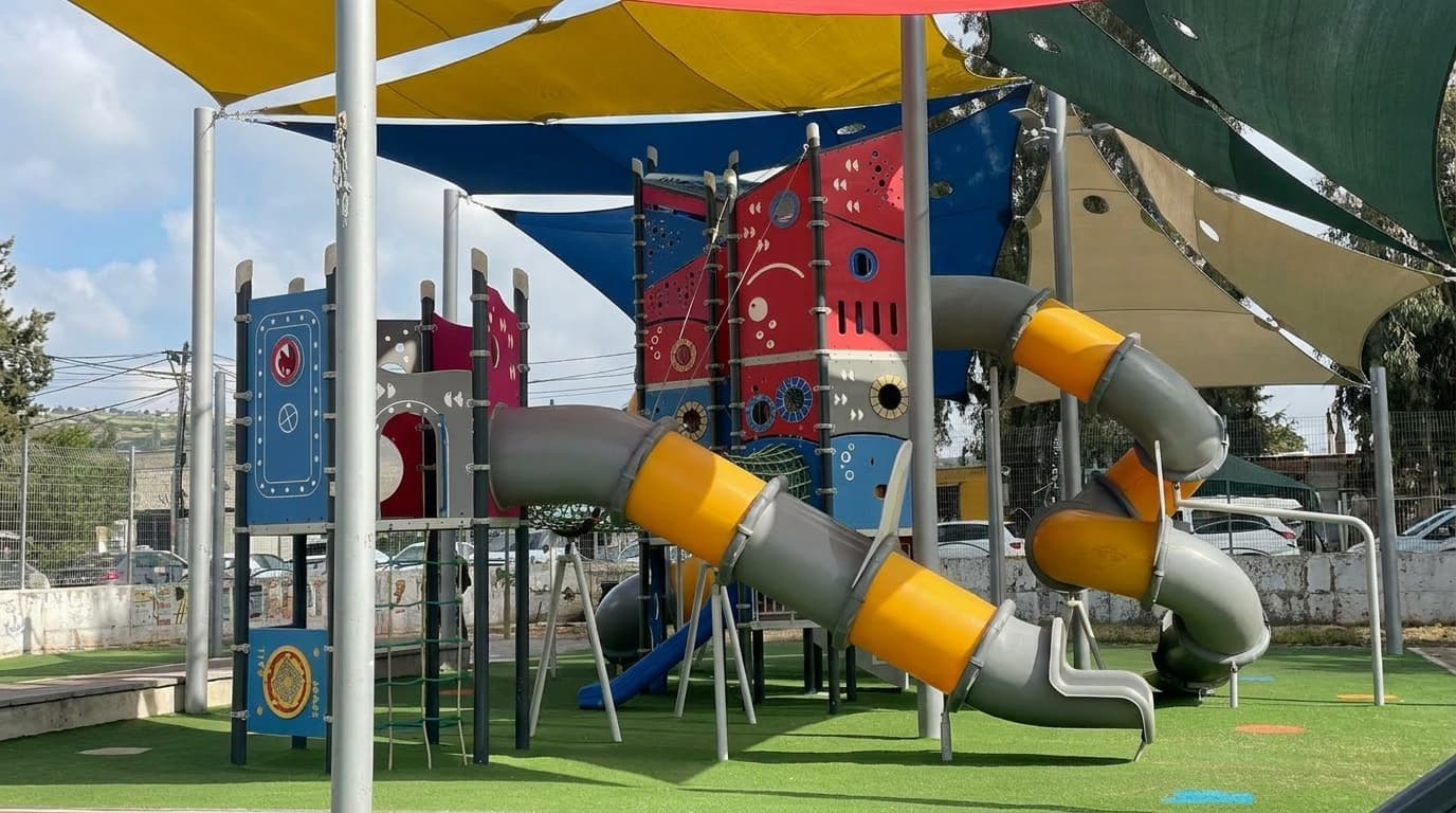 Large playground slide and climbing area at Mas'ada Park