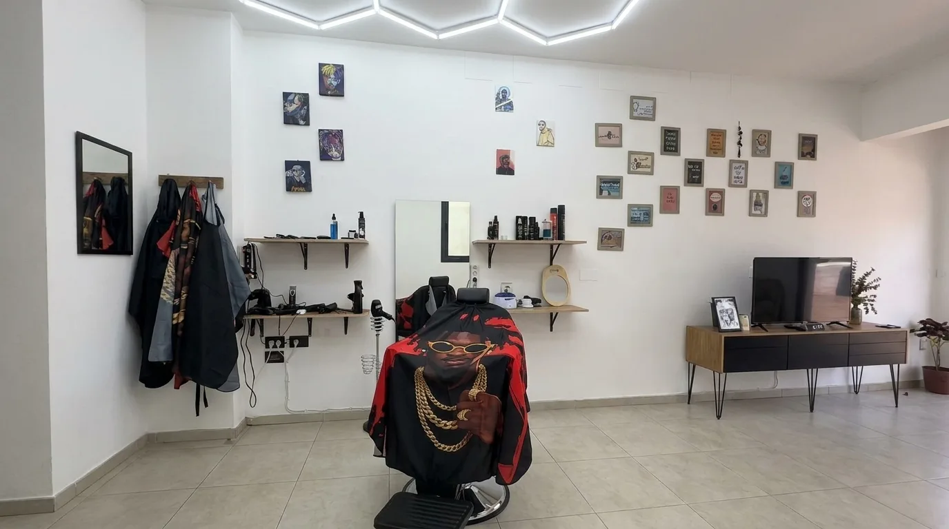 Black and red barber chair beneath hexagonal ceiling lights