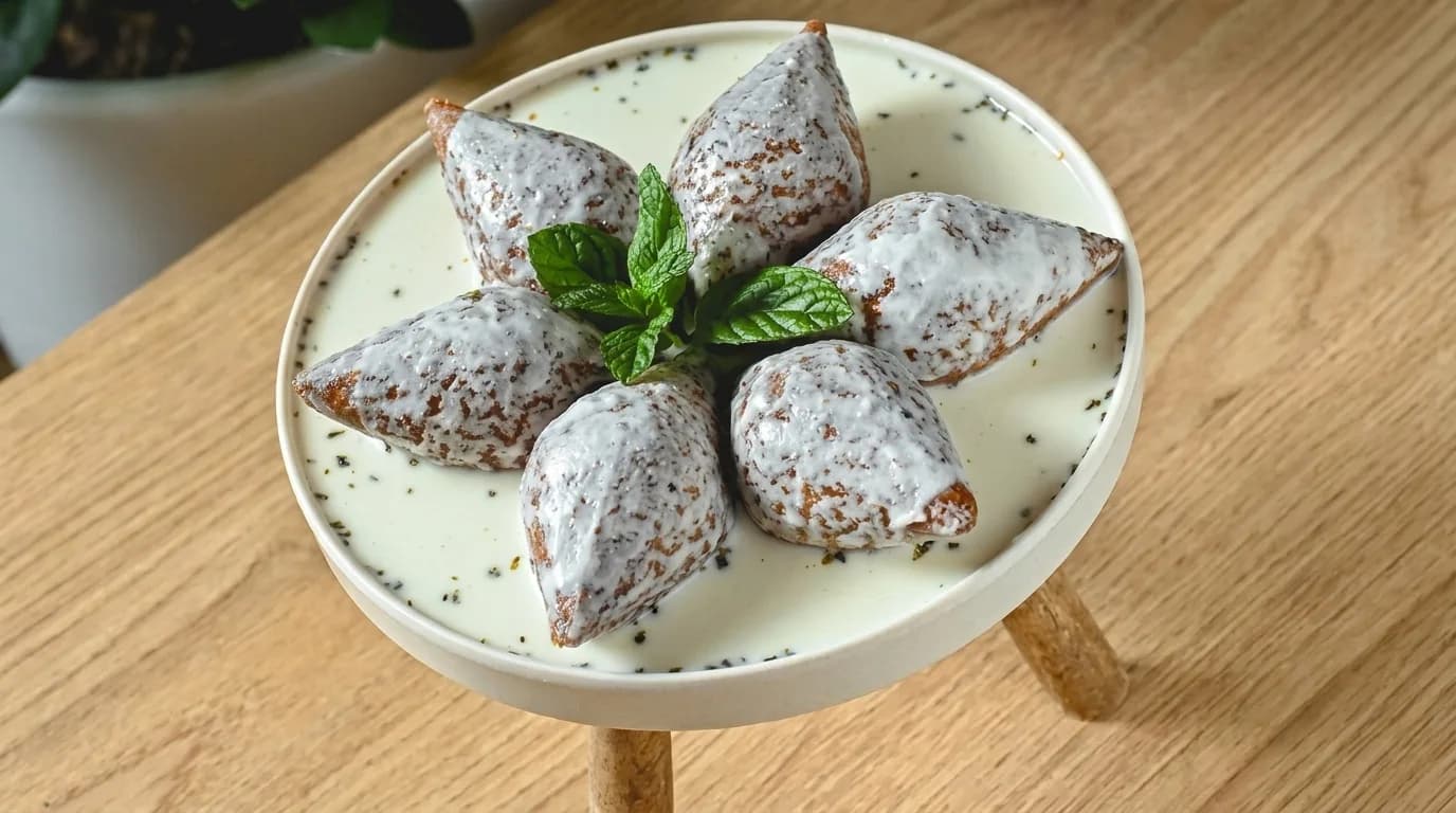 Filled pieces served in a white sauce with mint at Merci Restaurant & Cafe