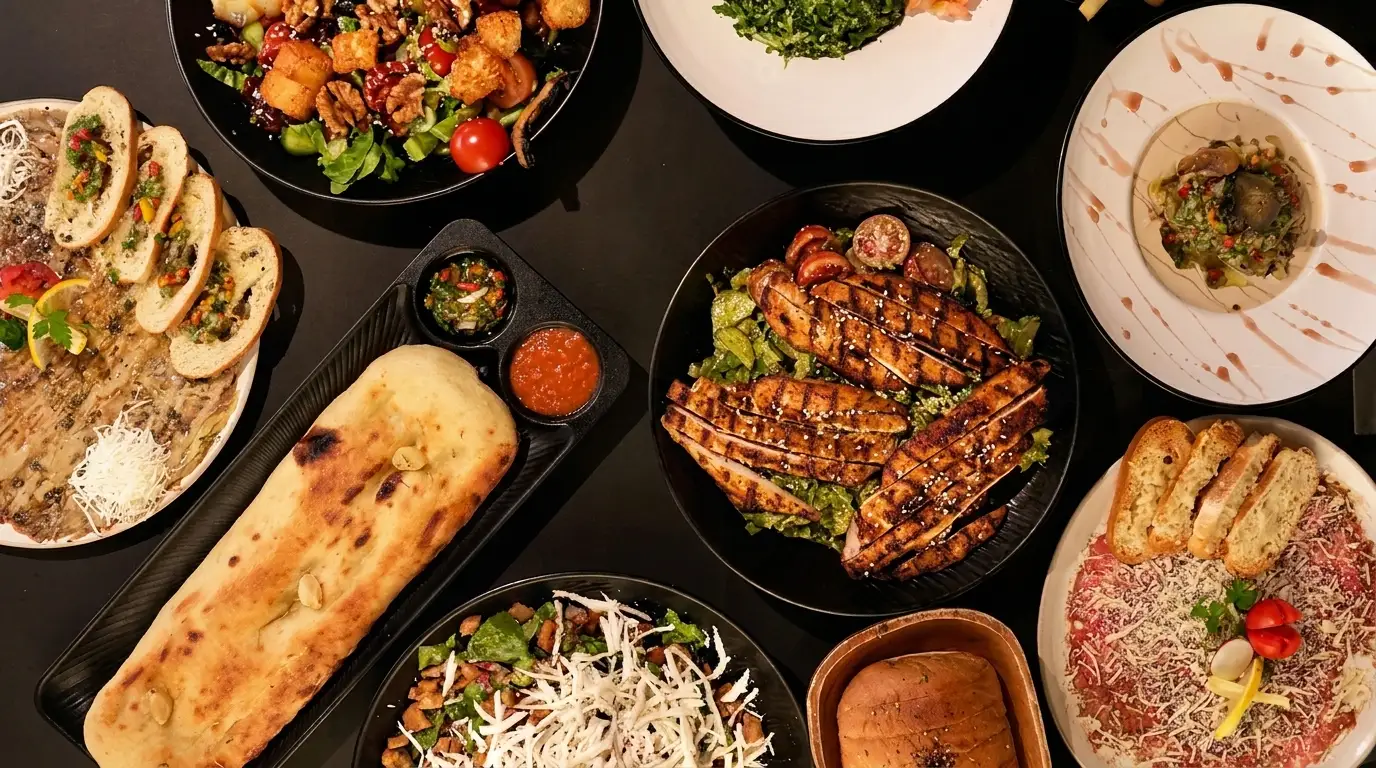 Table spread with assorted dishes at Bab Sharqi Restaurant in Majdal Shams